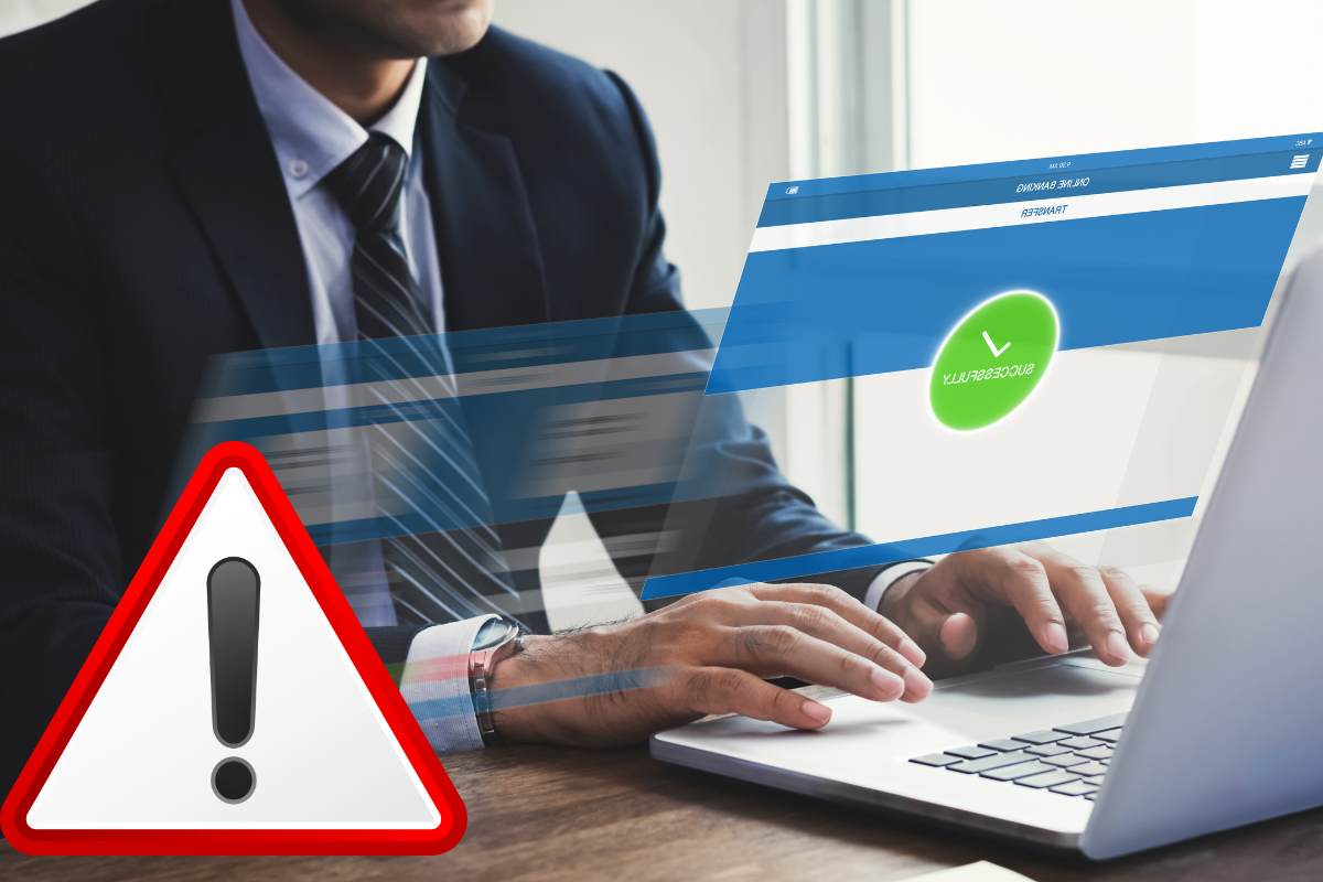 uomo al computer e segno attenzione